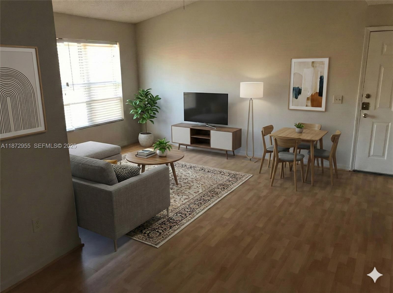 4201 West McNab Road, Unit 27 Pompano Beach, FL 33069 - Photo 12 of 15 a living room with furniture a flat screen tv and a window