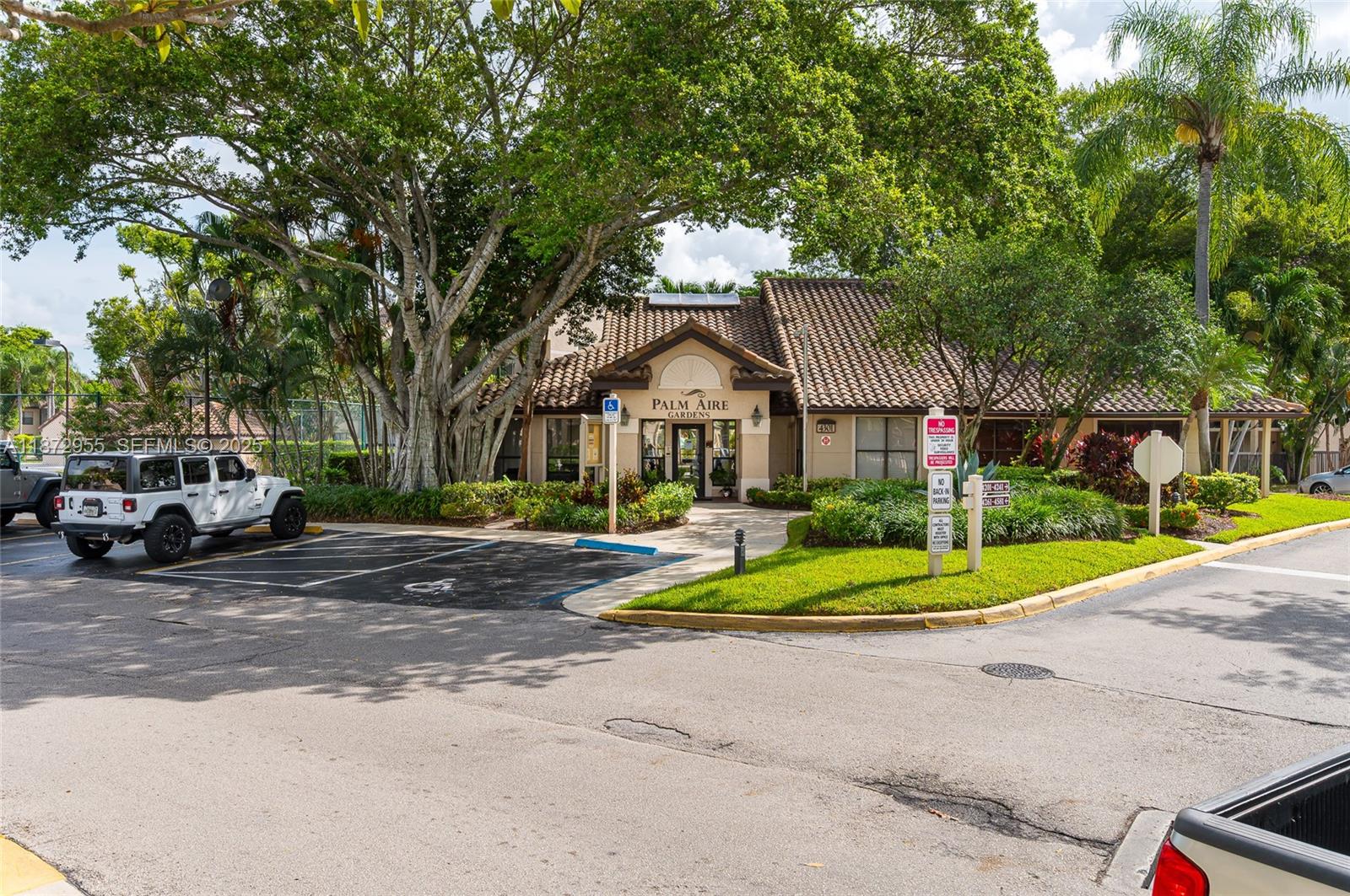 4201 West McNab Road, Unit 27 Pompano Beach, FL 33069 - Photo 7 of 15 a front view of a house with a yard and garage