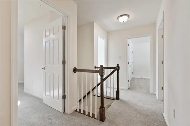 a view of a hallway with wooden floor and entryway
