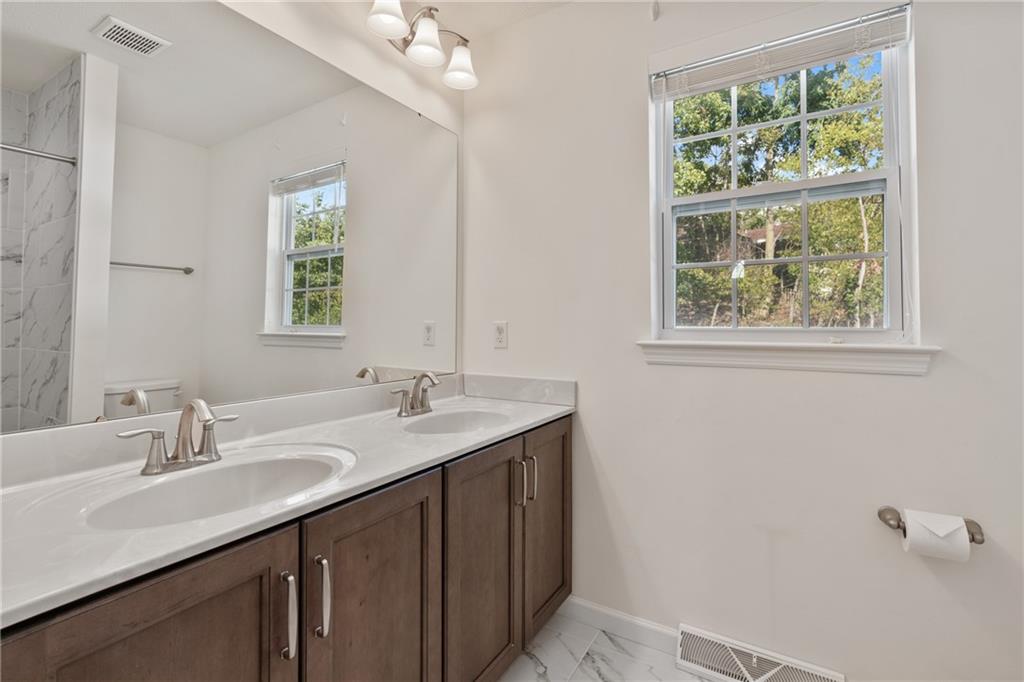 203 Southview Road Pittsburgh, PA 15237 - Photo 22 of 34 a bathroom with a granite countertop sink a large mirror and a window