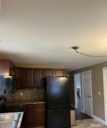 a bathroom with a granite countertop toilet and a sink