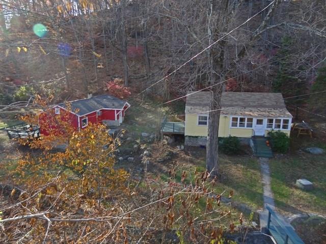 a view of a house with a backyard and a garden