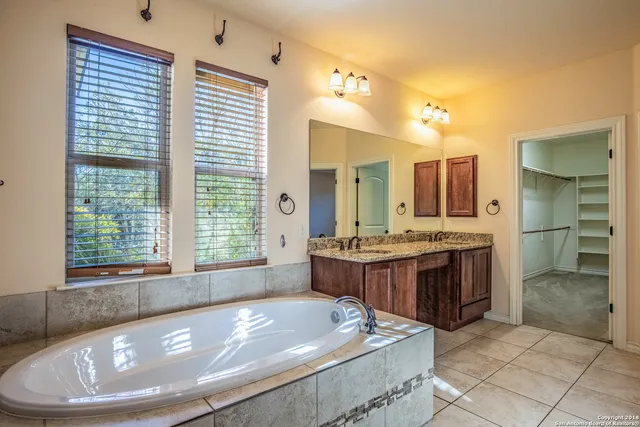 a large bathroom with a large tub and sink