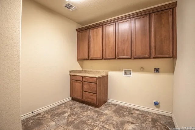 a view of storage and utility room with closet