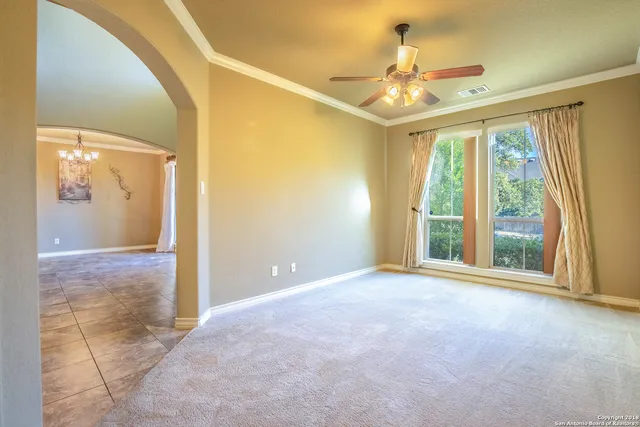 a view of a livingroom with an empty space and a window