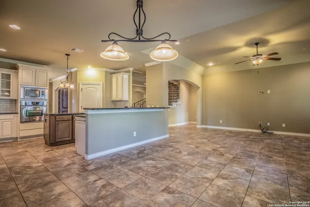 a view of a kitchen with a sink and refrigerator