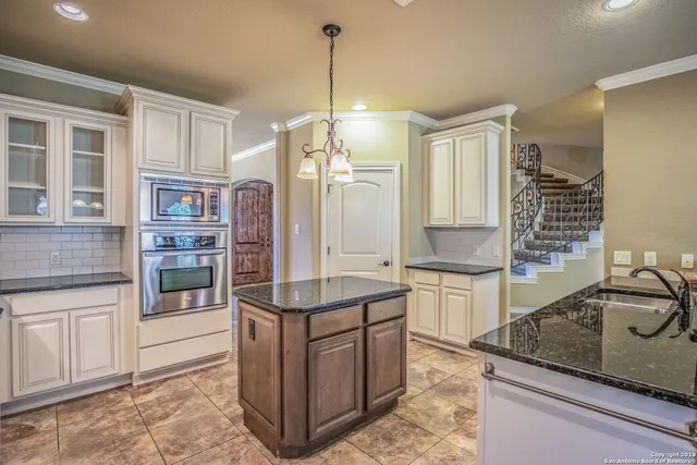 a kitchen with a sink stove and cabinets