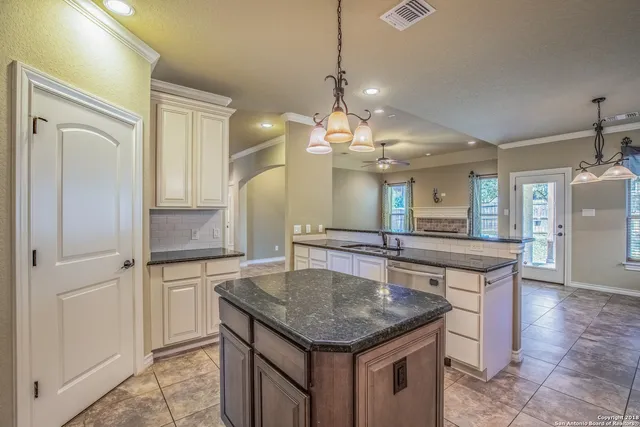 a kitchen with a table and refrigerator