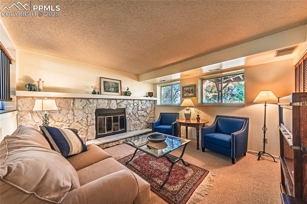 422 Saddlemountain Road Colorado Springs, CO 80919 - Photo 11 of 30 a living room with furniture and a fireplace