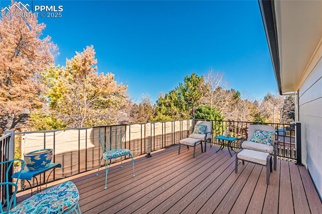 422 Saddlemountain Road Colorado Springs, CO 80919 - Photo 15 of 30 a balcony with wooden floor table and chairs