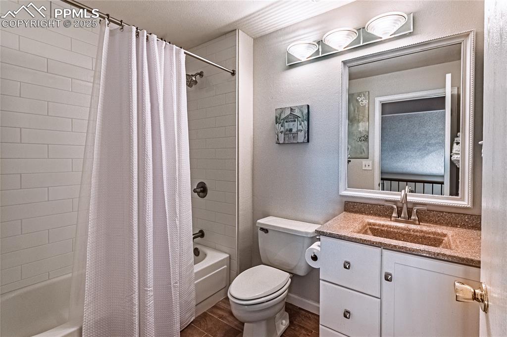 422 Saddlemountain Road Colorado Springs, CO 80919 - Photo 18 of 30 a bathroom with a granite countertop toilet sink and a mirror