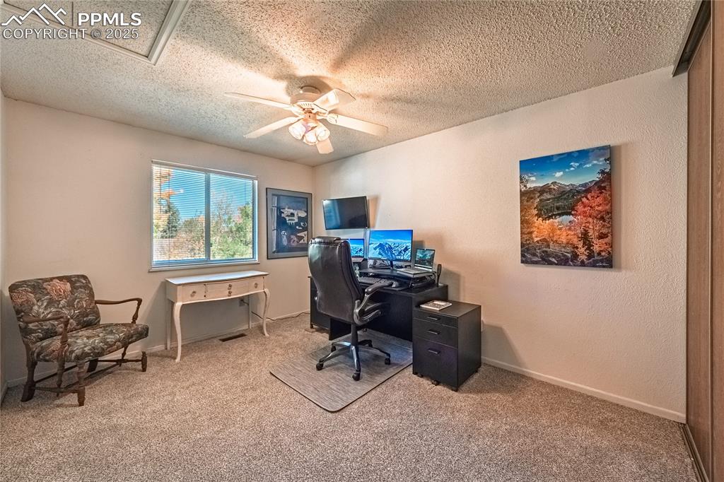 422 Saddlemountain Road Colorado Springs, CO 80919 - Photo 19 of 30 a view of a workspace with furniture and a window
