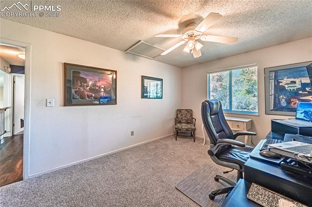 422 Saddlemountain Road Colorado Springs, CO 80919 - Photo 20 of 30 a view of a workspace with furniture and a window