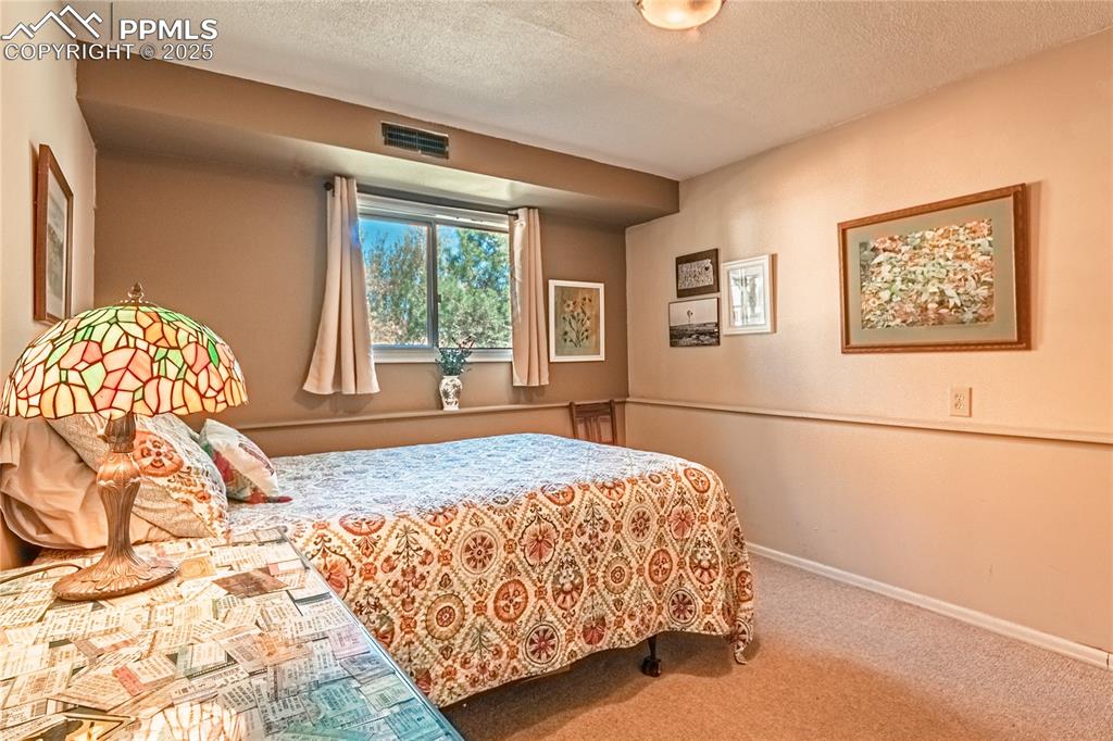 422 Saddlemountain Road Colorado Springs, CO 80919 - Photo 21 of 30 a bedroom with a bed and a window