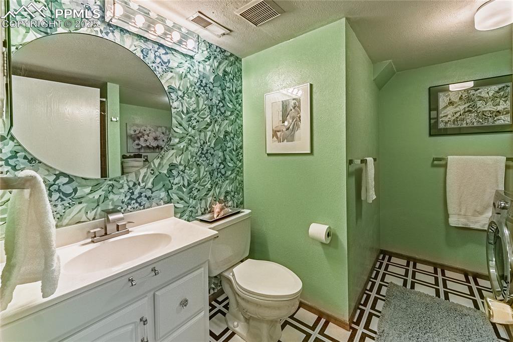 422 Saddlemountain Road Colorado Springs, CO 80919 - Photo 23 of 30 a bathroom with a toilet sink and mirror