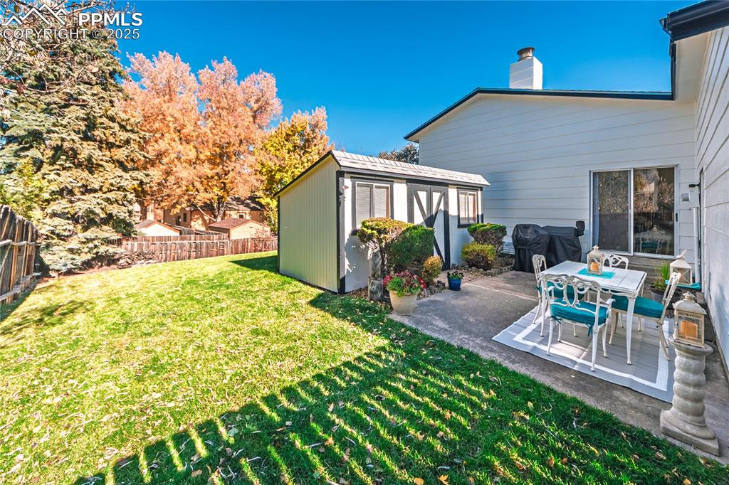 422 Saddlemountain Road Colorado Springs, CO 80919 - Photo 25 of 30 a view of a chair and table in backyard of the house
