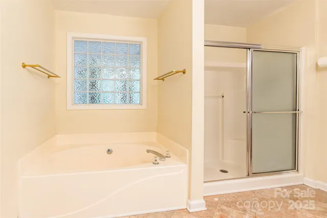 a bathroom with a bathtub and a shower