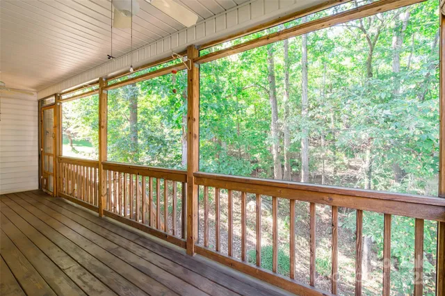 a view of a forest with trees in front of a house