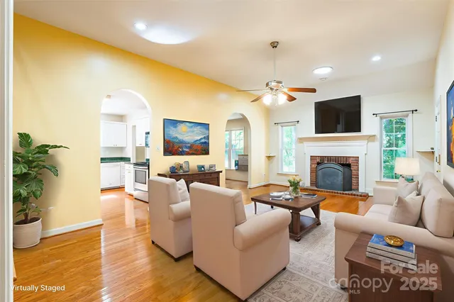 a living room with furniture fireplace and flat screen tv