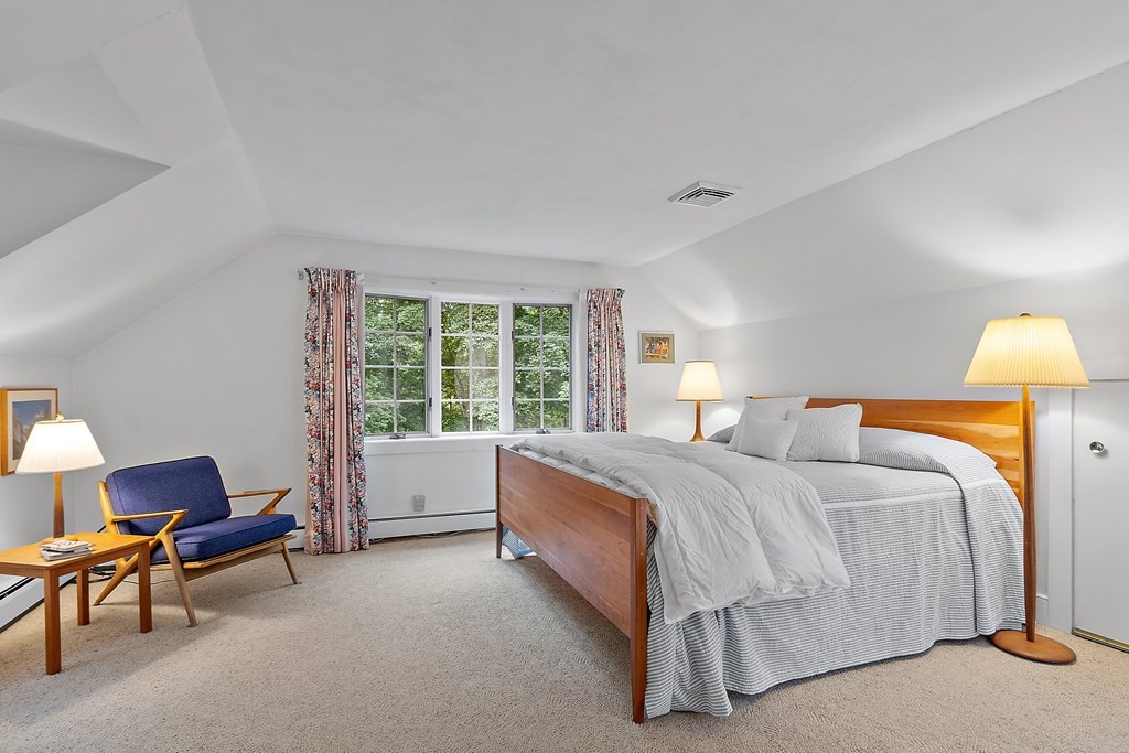 23 Bennington Road Lexington, MA 02421 - Photo 30 of 42 a bed room with a bed and a chair
