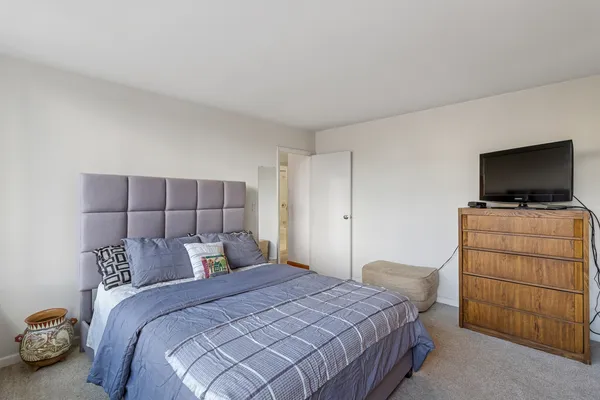 a bedroom with a bed and flat screen tv