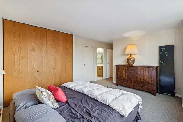 a bedroom with a bed and a dresser