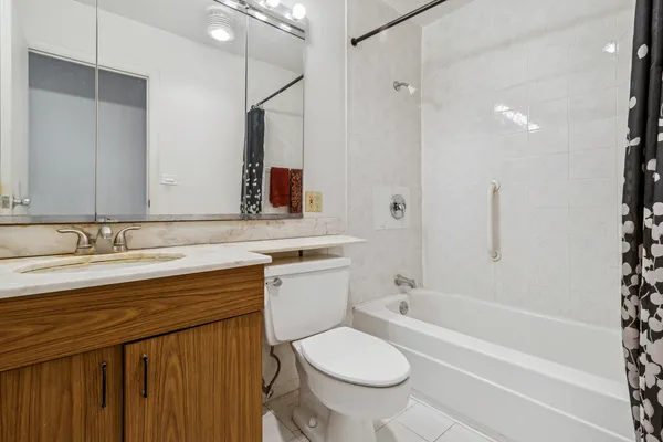 a bathroom with a sink toilet a mirror and shower