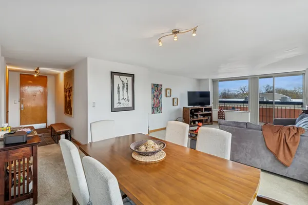 a view of a dining room with furniture large window and wooden floor