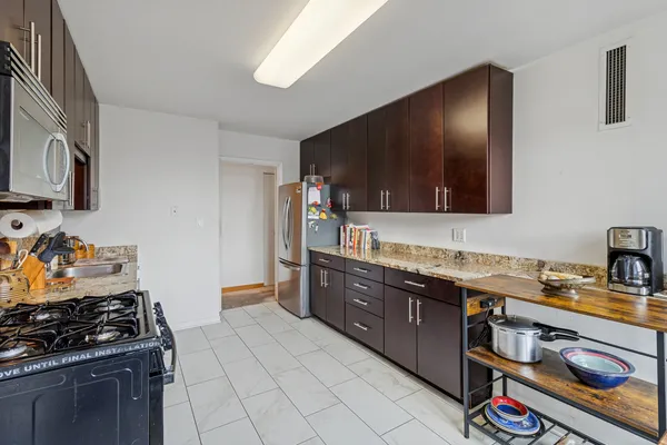 a kitchen with stainless steel appliances granite countertop a stove and a sink