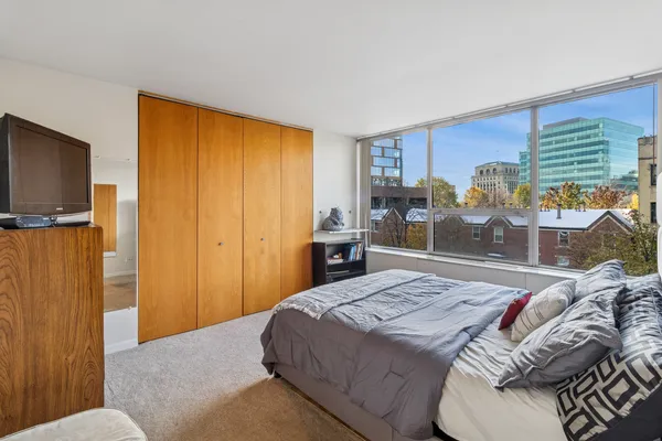 a bedroom with a bed and a flat tv screen