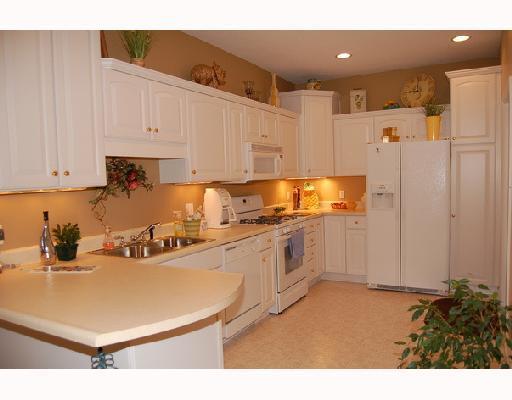 311 Saddlebrook Road Gibsonia, PA 15044 - Photo 5 of 8 Kitchen. The kitchen with its abundance of white cabinets, crown moldings, and the neutral countertop speaks elegance.