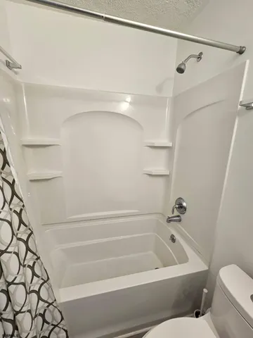 a bathroom with a bathtub and a shower