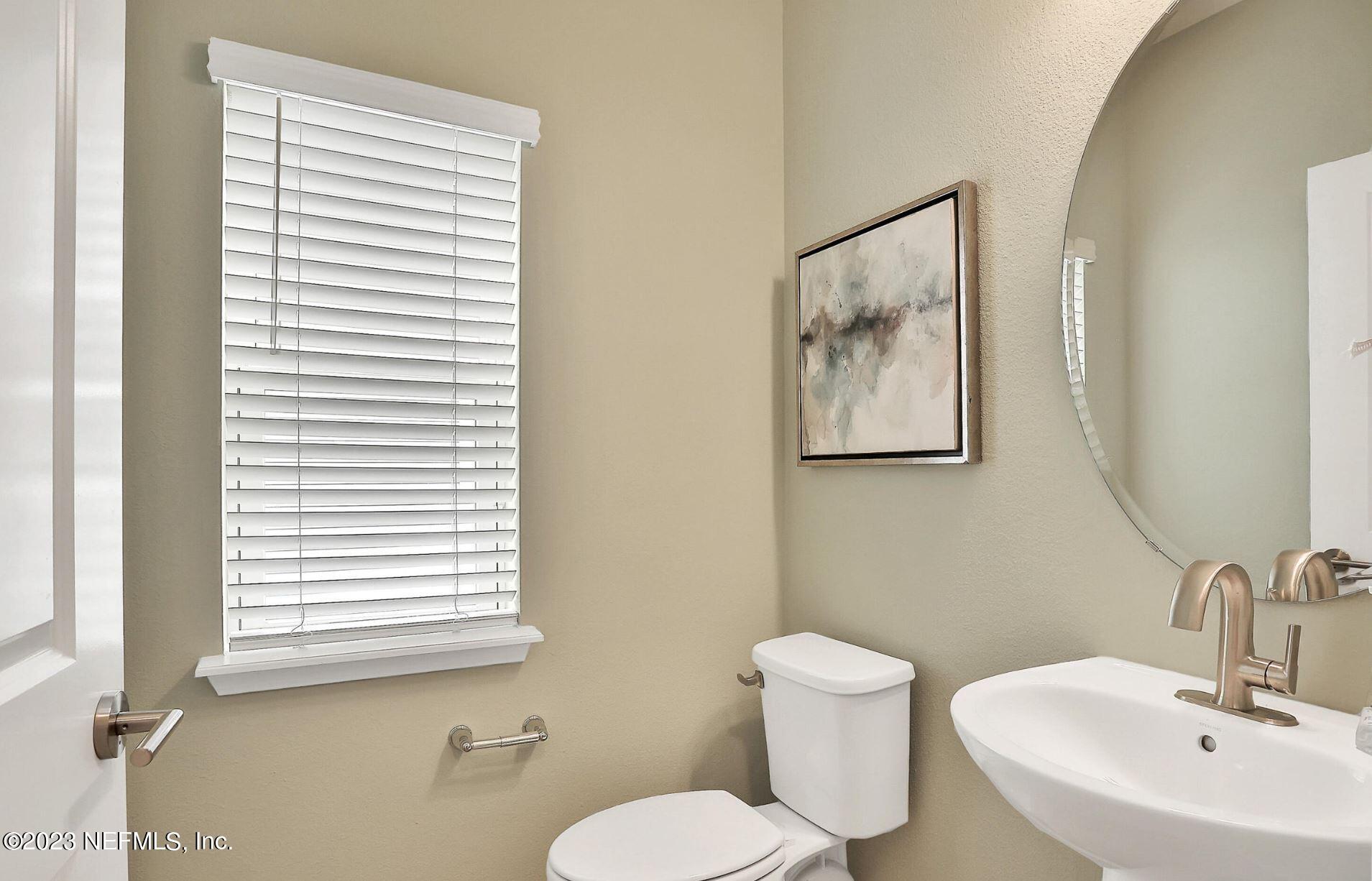76 Archstone Way St. Augustine, FL 32092 - Photo 14 of 49 a bathroom with a toilet a sink and mirror