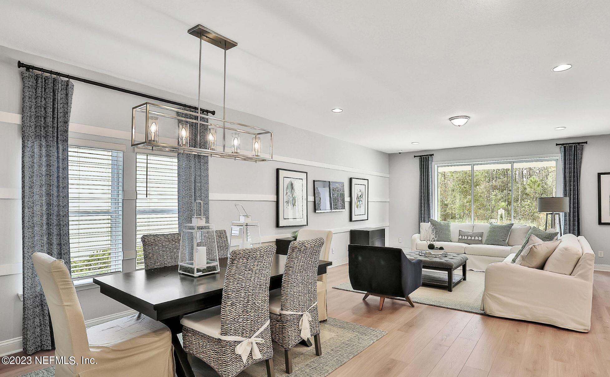 76 Archstone Way St. Augustine, FL 32092 - Photo 15 of 49 a living room with furniture large window and wooden floor