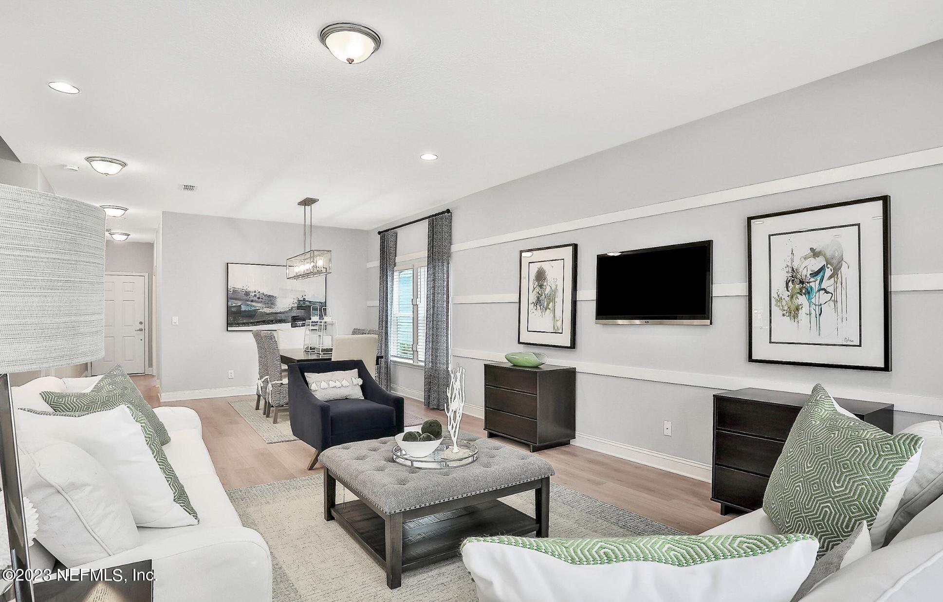 76 Archstone Way St. Augustine, FL 32092 - Photo 20 of 49 a living room with furniture a flat screen tv and kitchen view