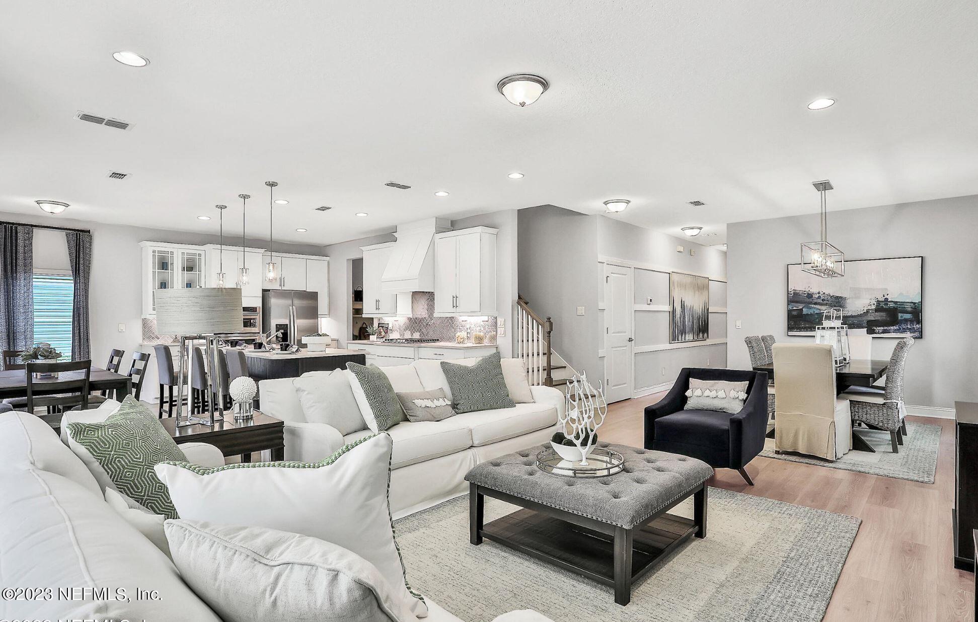 76 Archstone Way St. Augustine, FL 32092 - Photo 21 of 49 a living room with furniture kitchen view and a table