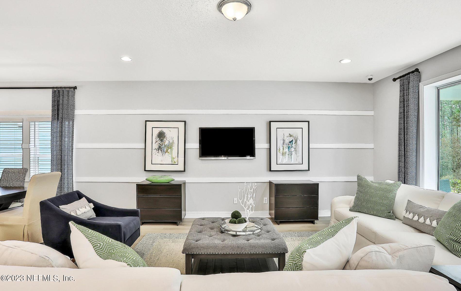 76 Archstone Way St. Augustine, FL 32092 - Photo 22 of 49 a living room with furniture and a fireplace