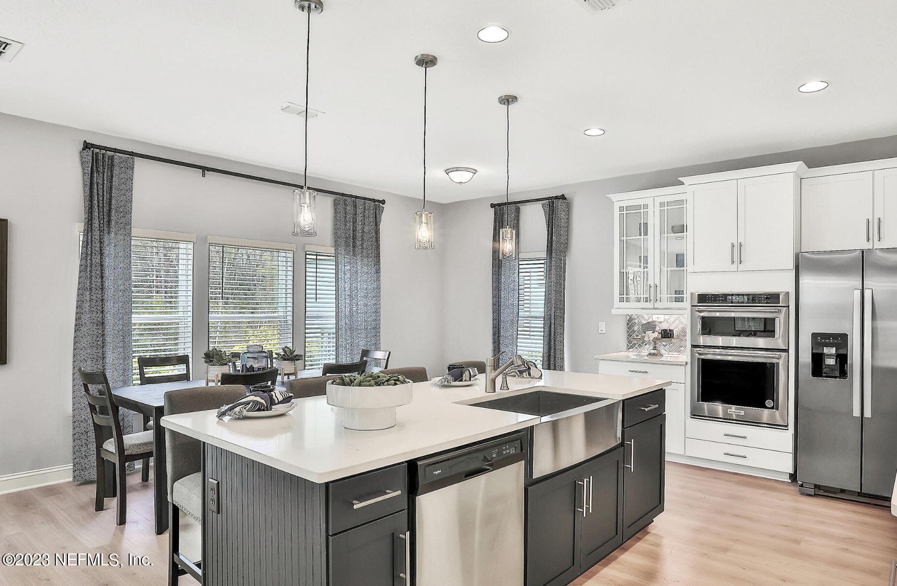 76 Archstone Way St. Augustine, FL 32092 - Photo 24 of 49 a kitchen with stainless steel appliances kitchen island a sink stove and refrigerator