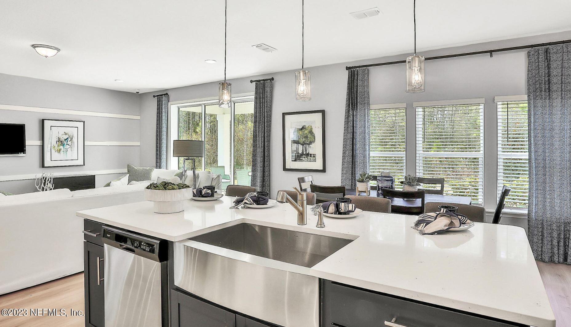 76 Archstone Way St. Augustine, FL 32092 - Photo 26 of 49 a kitchen with sink refrigerator and large window
