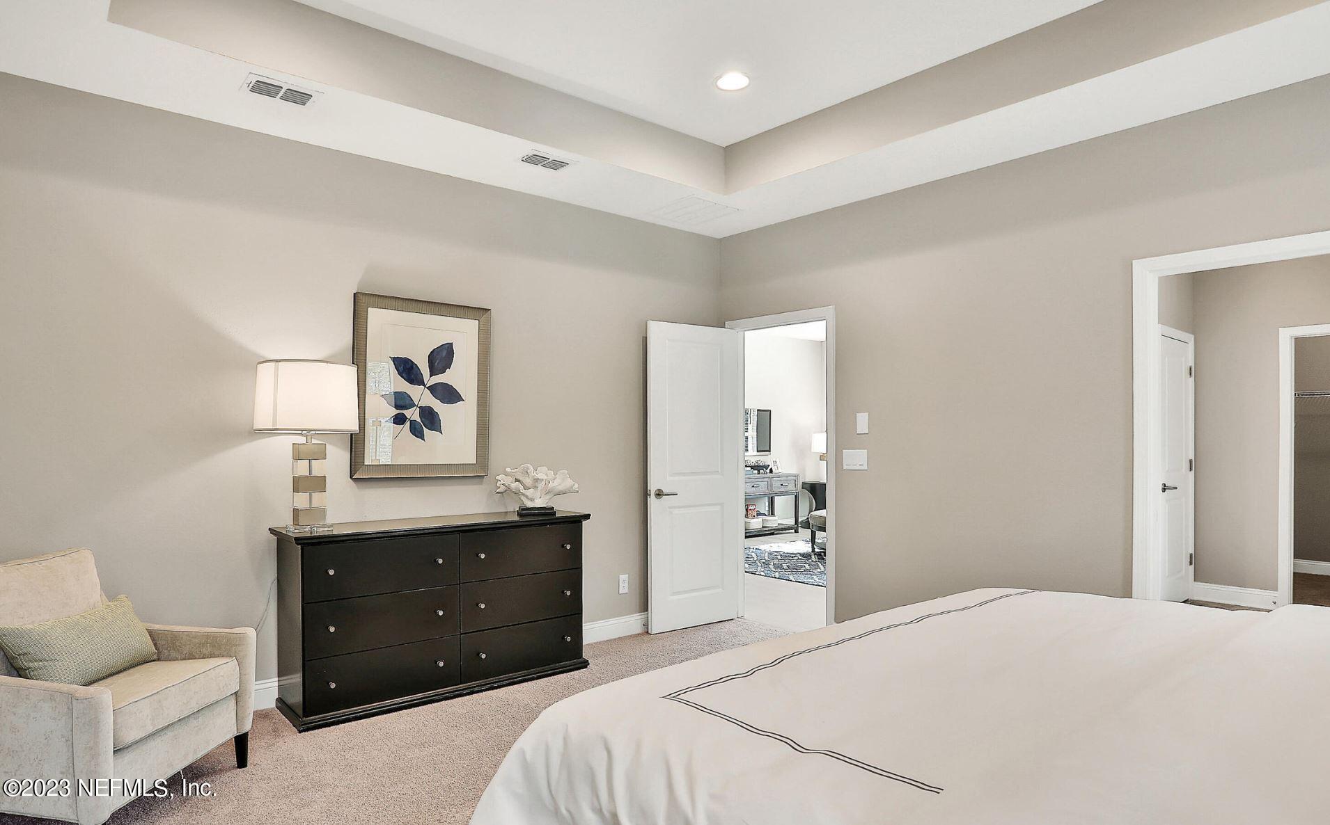 76 Archstone Way St. Augustine, FL 32092 - Photo 36 of 49 a bedroom with a bed and a desk