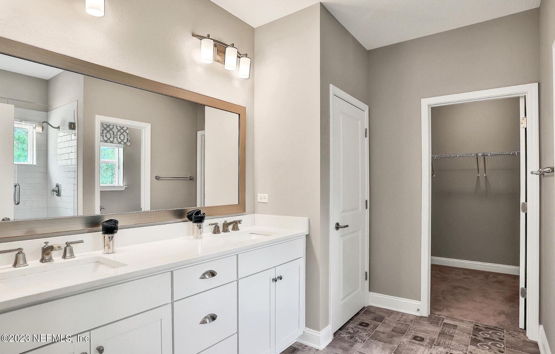 76 Archstone Way St. Augustine, FL 32092 - Photo 37 of 49 a bathroom with double sink and a mirror