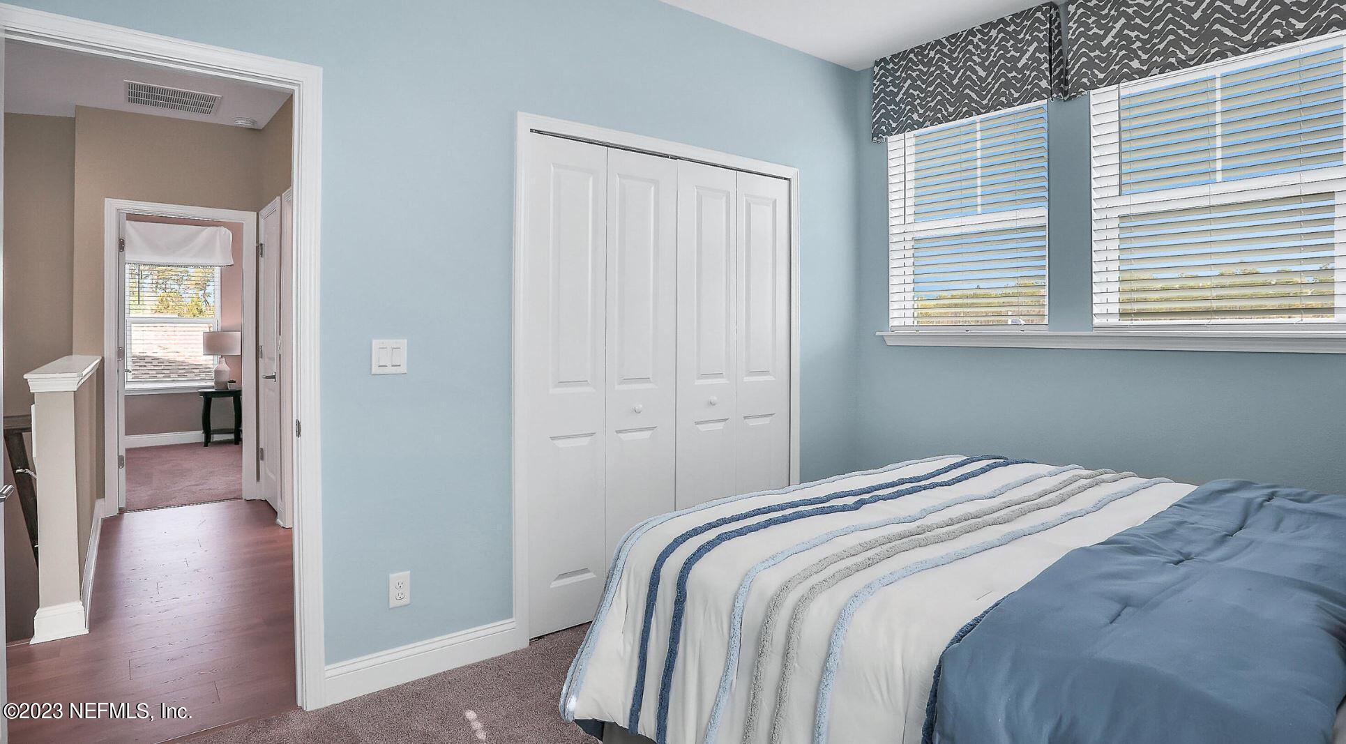 76 Archstone Way St. Augustine, FL 32092 - Photo 46 of 49 a bedroom with a bed and a view of en suite bathroom