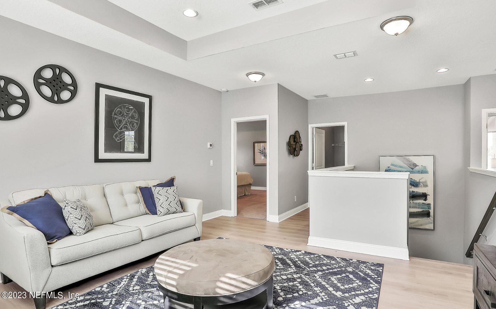 76 Archstone Way St. Augustine, FL 32092 - Photo 48 of 49 a living room with furniture and a rug