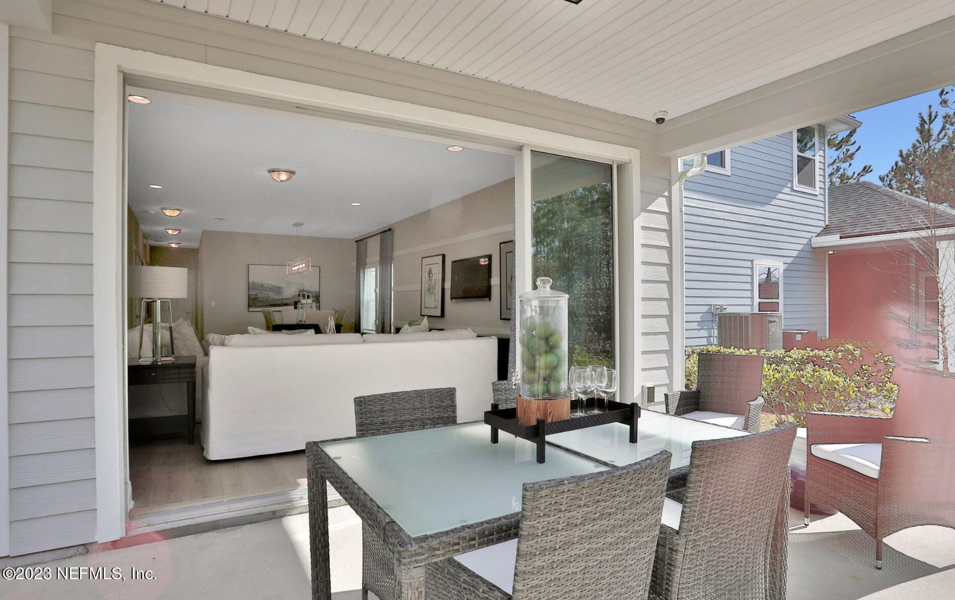 76 Archstone Way St. Augustine, FL 32092 - Photo 49 of 49 a living room with couches and kitchen view with wooden floor