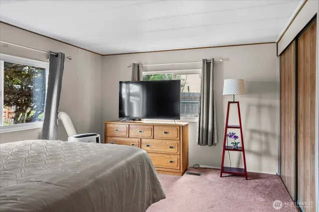 a bedroom with a large bed and a chandelier