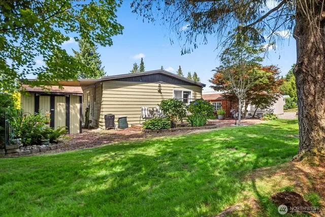 a view of a chair and tables in the house front a house