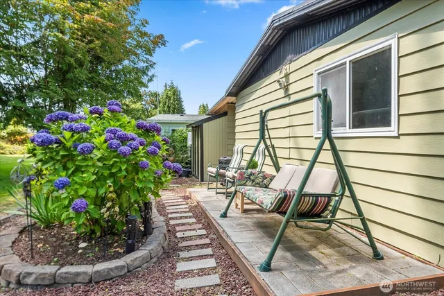 a view of a house with backyard and sitting area