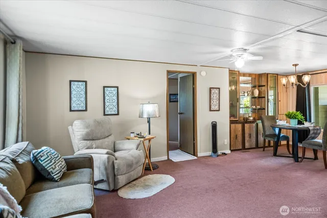a living room with furniture and a chandelier