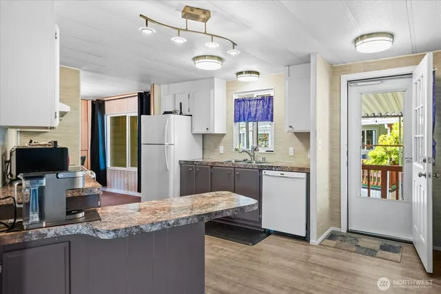 a kitchen with a sink a stove and cabinets