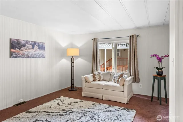 a living room with furniture and a rug